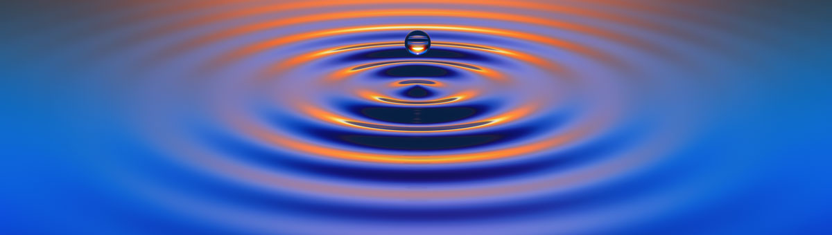 Water drops create ripples at sunset