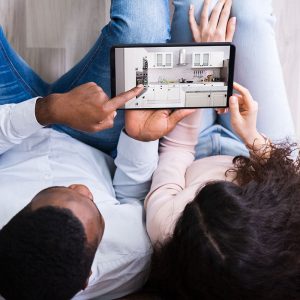 A couple viewing a kitchen design on a tablet